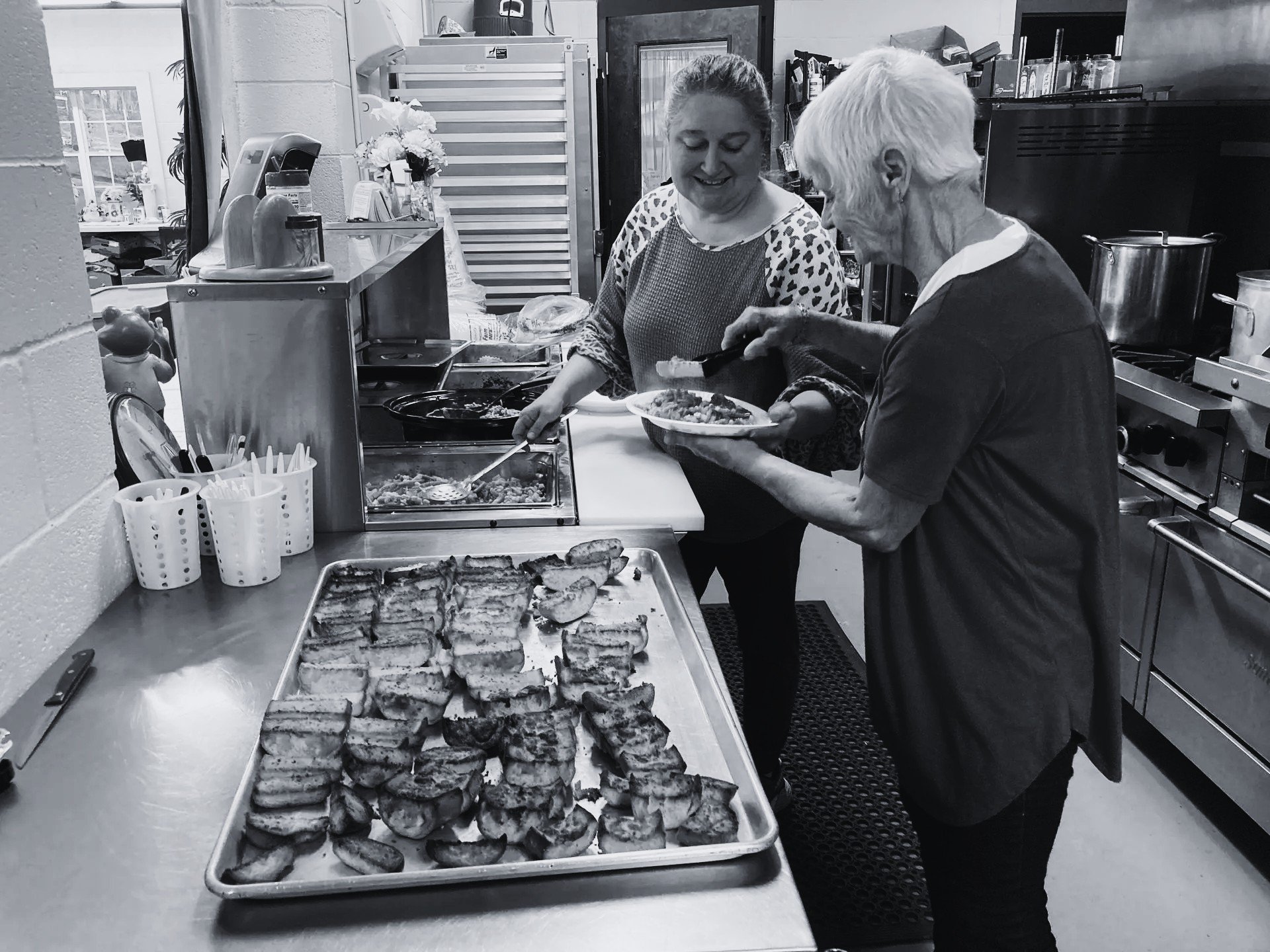 Volunteers preparing meals in the ECHO kitchen